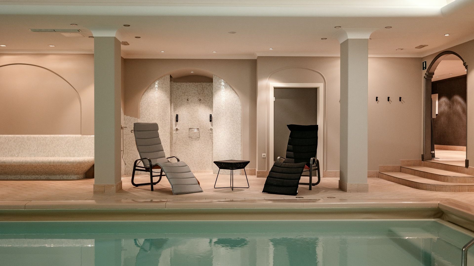 South Tyrol hotel with pool (3 stars): right here! Indoor pool with lounge chairs, shower, and seating area in a bright room
