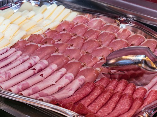 Cuisine at one of the top hotels in Grödnertal with 3 stars Assorted cold cuts and cheese slices on a serving tray