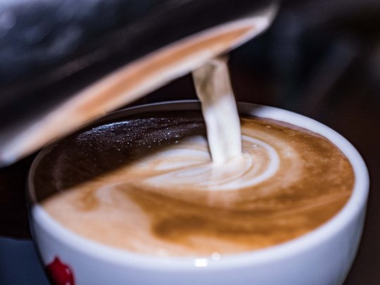 Cuisine at one of the top hotels in Grödnertal with 3 stars Milk foam being poured into a coffee cup for latte art