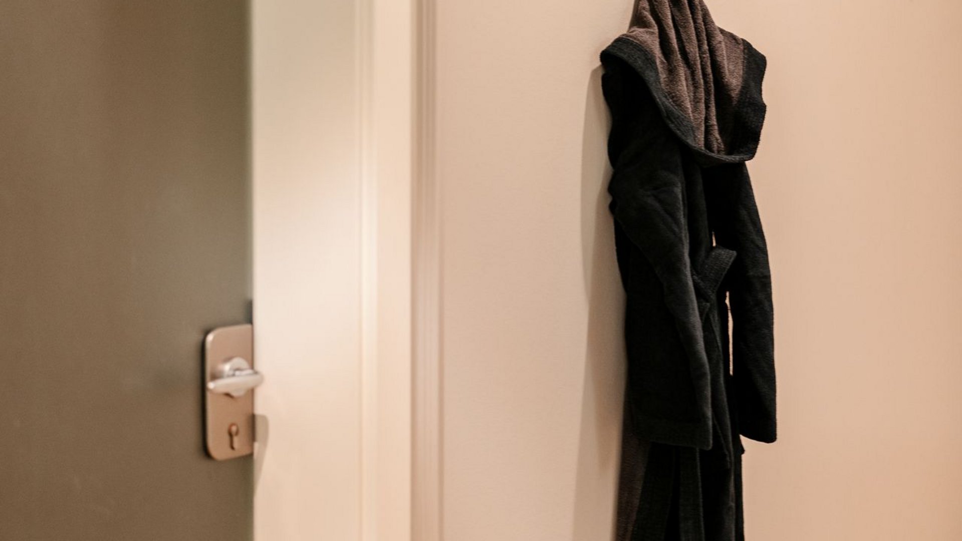 South Tyrol hotel with pool (3 stars): right here! Black bathrobe hanging on wall hooks next to closed door